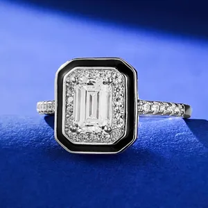 Anillo de plata con talla esmeralda, elegante borde de esmalte negro y halo de circones.
