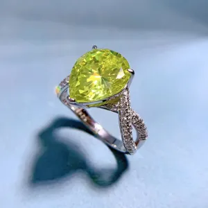Close-up detail of the elegant pear-cut olive green high-carbon diamond ring with pave band.