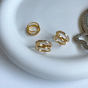 Gold-plated double band ring with sparkling cubic zirconia, modern minimalist jewelry.