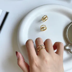Gold plated crystal double band ring detail shot, elegant fashion jewelry accessory design.