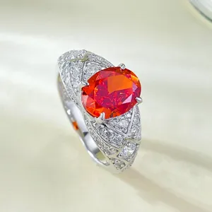 Close-up detail shot showcasing the brilliant sunset orange stone on the silver ring.