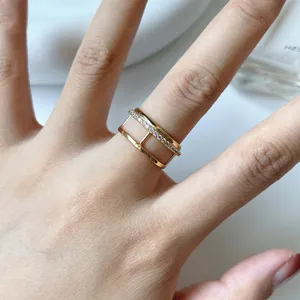 Gold S925 silver double band ring with sparkling cubic zirconia, stylish detail shot.