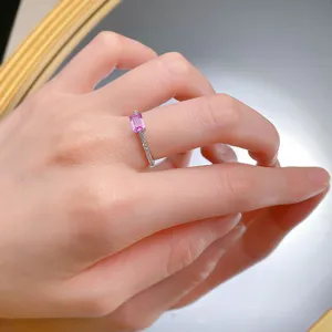 Exquisite pink emerald-cut gemstone ring close-up showcase worn on elegant hand