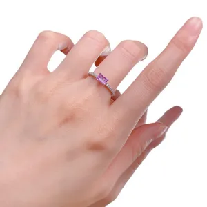 Elegant sterling silver ring featuring an emerald-cut pink gemstone and sparkling pave stones.