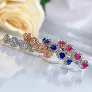 Detailed view of multi-color gemstone halo ring set with sparkling CZ stones and silver band.