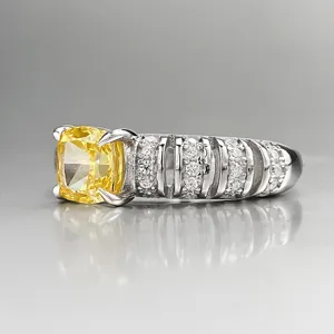 Detailed shot of S925 silver cushion yellow diamond ring with paved white stones.