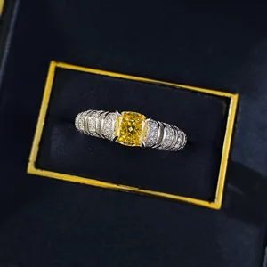 Detailed close-up of a luxury cushion cut yellow diamond ring set in a black jewelry box.
