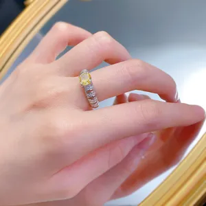 Close-up detail of a luxury European style 925 silver yellow diamond ring with micro pave stones.