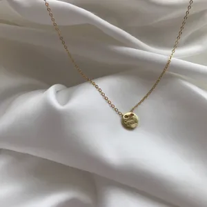 Gold-plated silver chain necklace with a delicate engraved Good Luck round pendant.