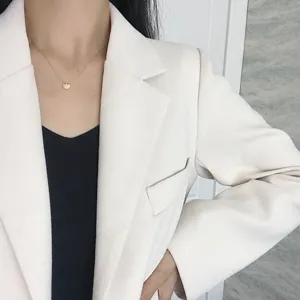 Detailed view of fashionable gold small round disc pendant necklace, elegant style for women.