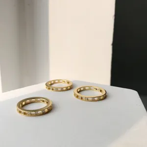 Close-up detail shot of exquisite gold-plated S925 silver rings with sparkling stones.