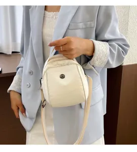 Minimalist white shell crossbody bag for women, versatile shoulder tote with top handle.