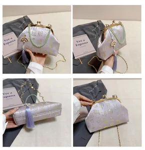 Chinese style jacquard evening bag with kiss-lock closure, pearl tassel and chain strap.