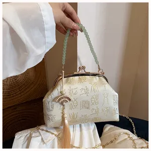Elegant Chinese style kiss-lock evening bag with bead handle and embroidered satin fabric.
