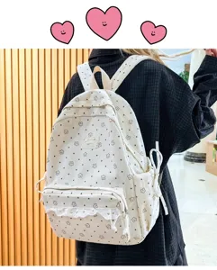 Close-up detail of a beige corduroy backpack with cute floral pattern and cute ruffles on front.