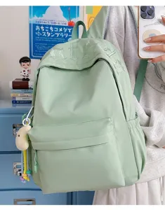 Detailed view of large capacity Japanese style green backpack with embroidered letters.