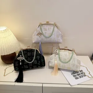 Chinese style vintage kiss-lock evening bag with pearl chain and tassel pendant, elegant.
