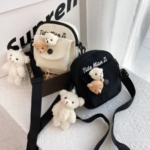 Japanese Harajuku cute canvas crossbody bag with plush bear pendant and pocket for daily use.
