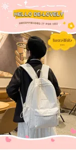 Detail view of simple white nylon lightweight school backpack in cafe scene setup.
