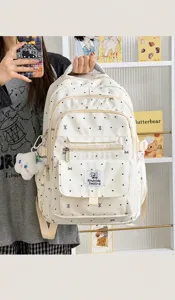 Zaino da donna con fiocco e pois, borsa scolastica casual ed elegante di colore beige.