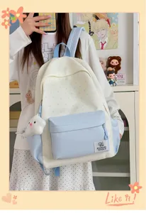 Detailed view of the Japanese style star print student backpack showing front pocket and cute charms.
