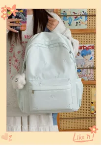 Mint green student backpack detail showing cute bow embroidery and casual daily design.
