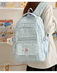 Zaino carino con stampa a pois e fiocco da donna, borsa casual alla moda per uso quotidiano.