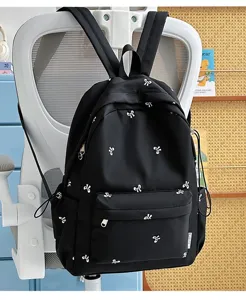 Korean style cute black student backpack with white bow prints, lightweight and casual daily bag.