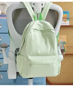Light green school backpack with cute bow embroidery for daily casual student and teen use.