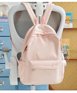 Cute pink school backpack with sweet bow embroidery for daily casual student use outdoor styling.