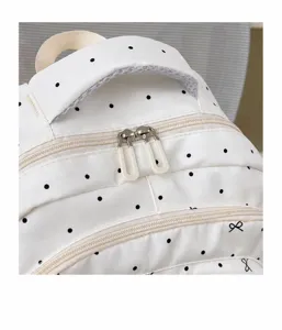 Zaino da donna con stampa a pois e fiocchi, borsa scolastica di tendenza con zip scorrevoli.