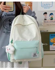 Canvas student backpack with cute star pattern and mint green pocket for casual daily use.
