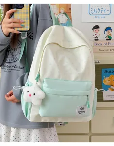 Detailed view of Japanese style light green and white star printed student backpack with cute cloud pendant.