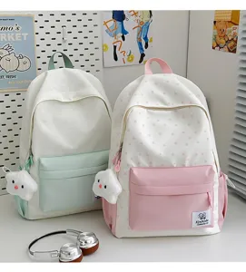 Detailed close-up view of casual student backpacks with star patterns, sweet pink and mint colors.