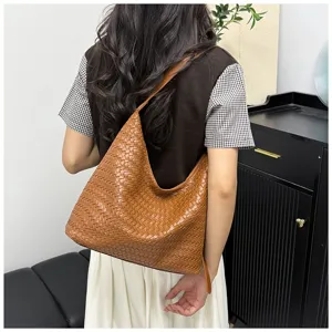 Detail view of the brown woven leather hobo shoulder bag showing its large capacity style.