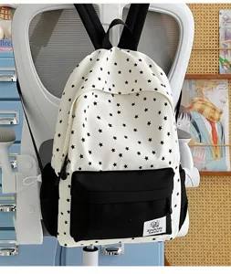 Detailed view of casual Japanese style white backpack with black star print and front pocket.