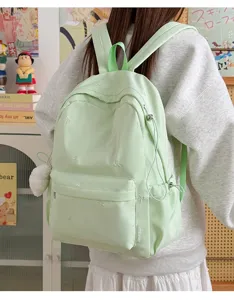 Light green student backpack with cute bow embroidery, casual school bag for teenagers.