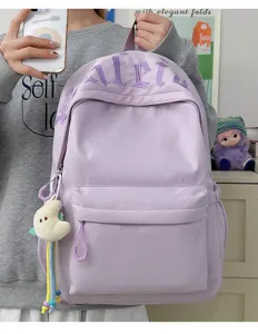 Minimalist large capacity purple school backpack with chic embroidery and cute plush pendant.