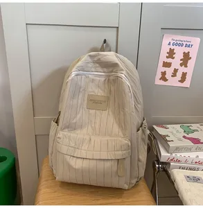 Minimalist pleated beige backpack for students, lightweight travel daily school book bag.