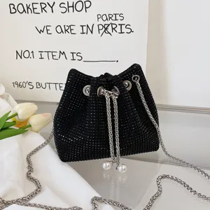 Black rhinestone bucket bag with sparkling crystals, metal chain and pearl drawstring.