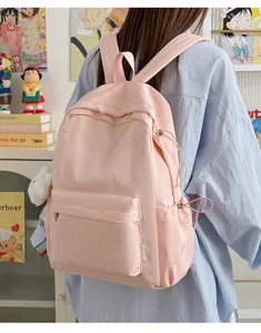 Korean style pink student backpack with cute embroidered bows, lightweight casual daily school bag.