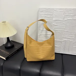 Yellow woven leather shoulder bag for women, stylish hobo tote bag for daily commute.