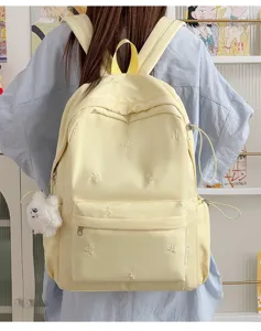 Korean style cute student school backpack with lovely bow embroidery and plush pendant for daily use.