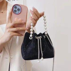 Black rhinestone bucket bag with pearl handle and chain strap, stylish designer crossbody bag for women.