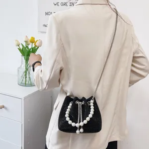 Black rhinestone bucket bag with elegant pearl handle and stylish metal chain strap for women.