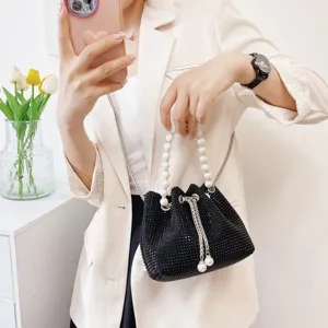 Detailed view of black rhinestone bucket bag with pearl handle and chain strap for women.