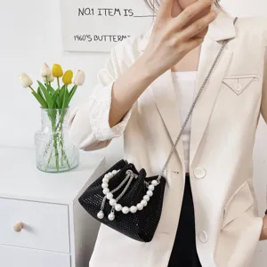 Chic black rhinestone bucket bag with elegant pearl handle and stylish chain strap for women.