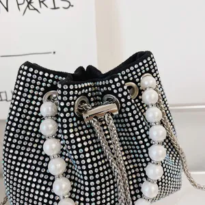 Rhinestone pearl bucket bag detail shot featuring sparkling crystals and pearls.