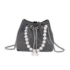 Sparkling rhinestone bucket bag with pearl handle and chain strap for women chic evening party.