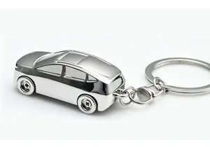 Detailed shot of a sleek silver metal car model keychain with polished finish and keyring.